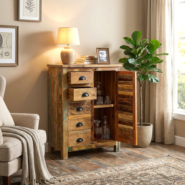 Solid wood highboard in the living room, open door and drawers, warm country house atmosphere